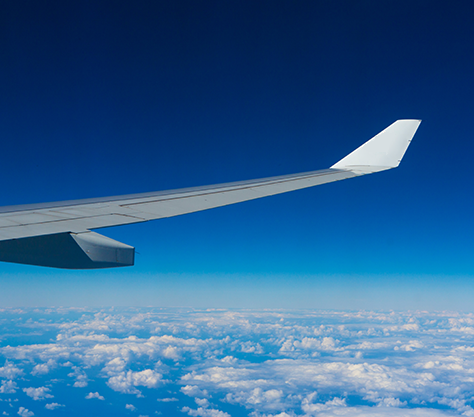 Aircraft above clouds with AeroShell logo