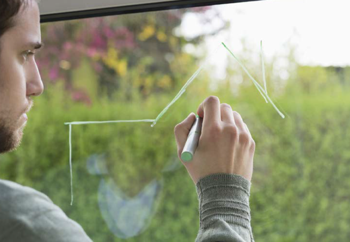 Person writing on glass with chemetell product