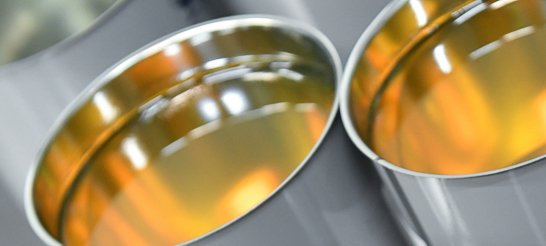 Aeroshell tins open with amber liquid inside