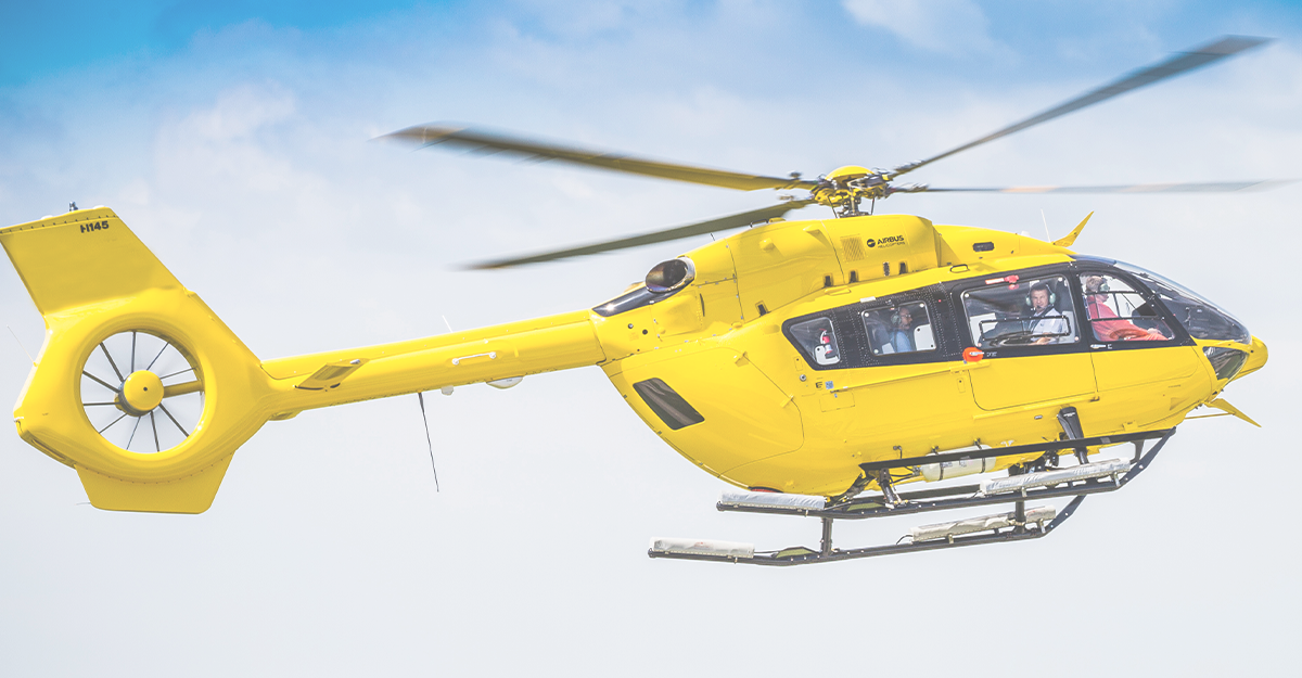 Yellow helicopter in flight