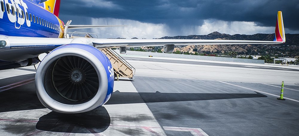 Turbine engine and wing of plane on tarmac