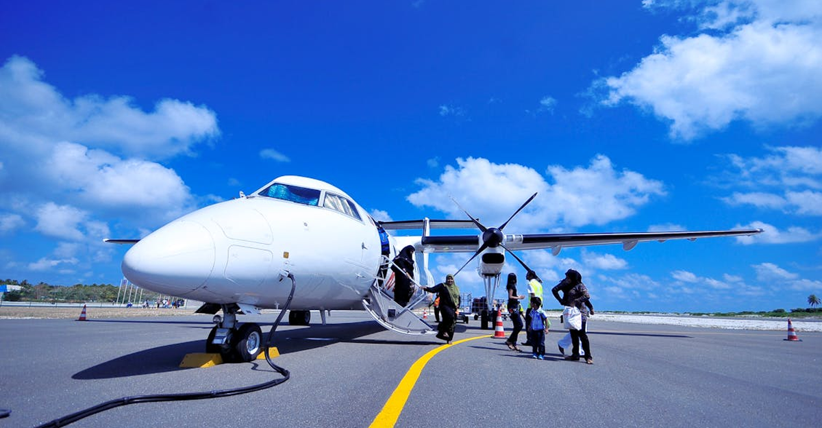 aeroplane on ground with passengers boarding