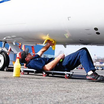 Person cleaning aircraft