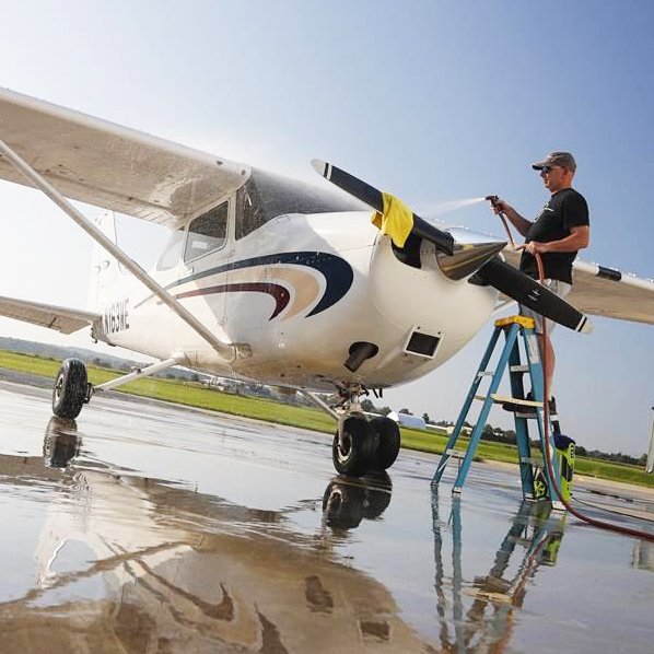 Small aircraft being sprayed