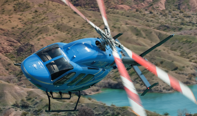 Blue helicopter in flight