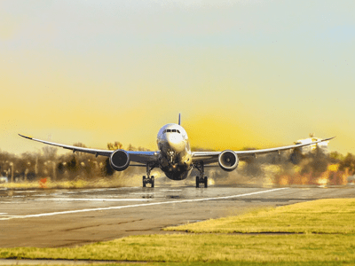 jet taking off against yellow sky