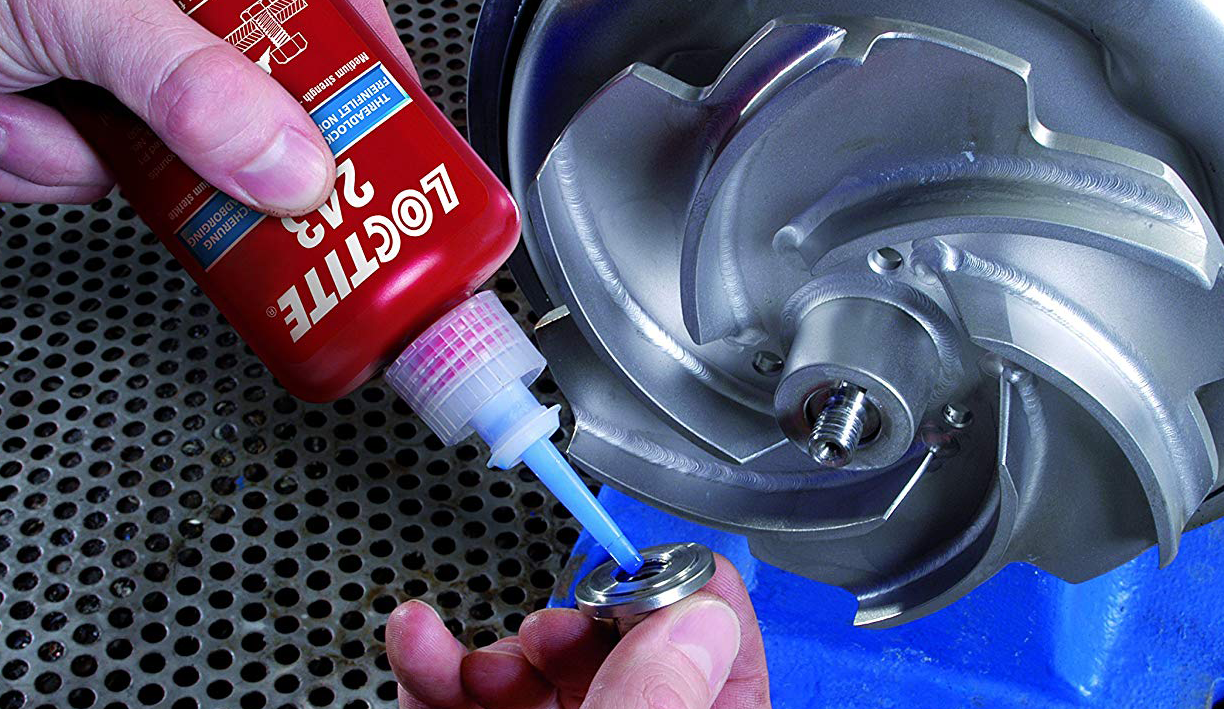 Loctite threadlocker being applied to a metal part