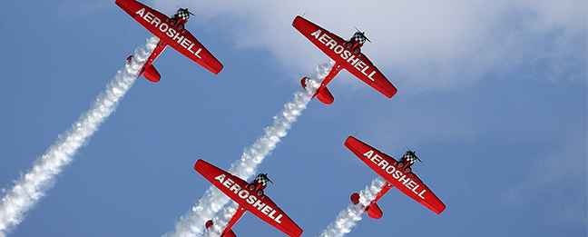 small Aeroshell planes with smoke trails