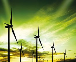 wind turbines against green sky