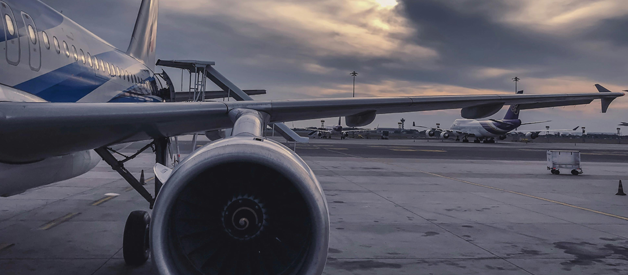 aeroplane on the ground against cloudy sky
