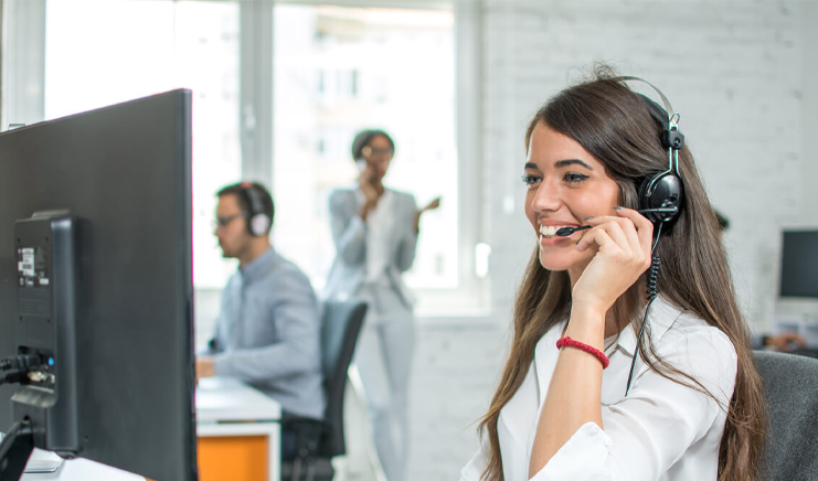 Office workers with computers and headsets