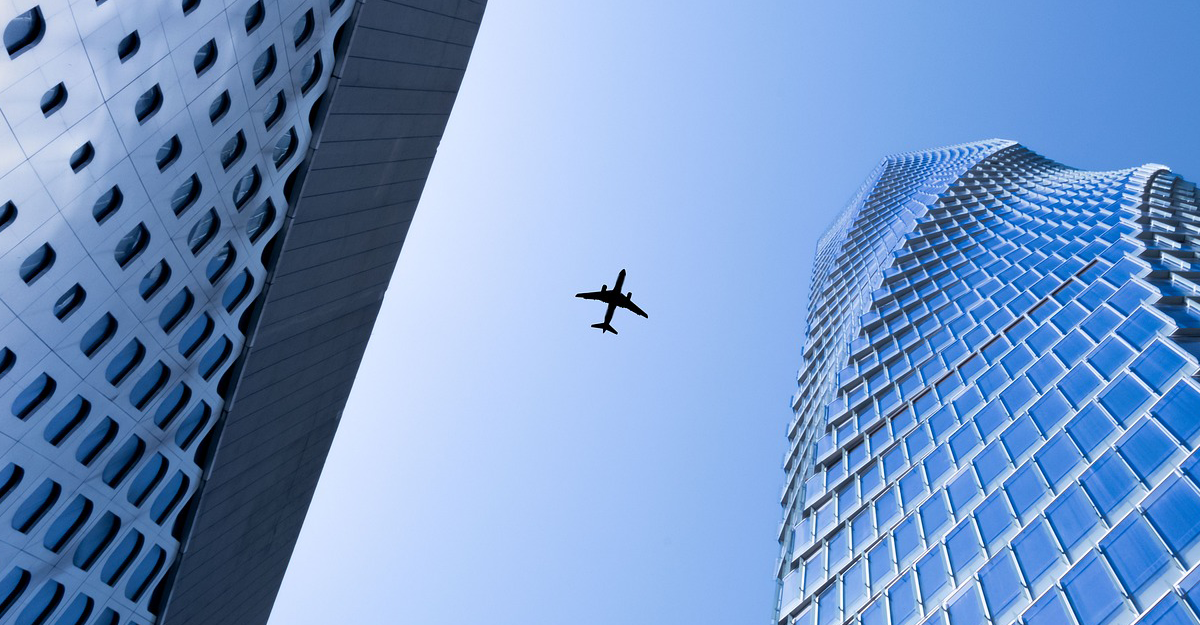 plane in between buildings