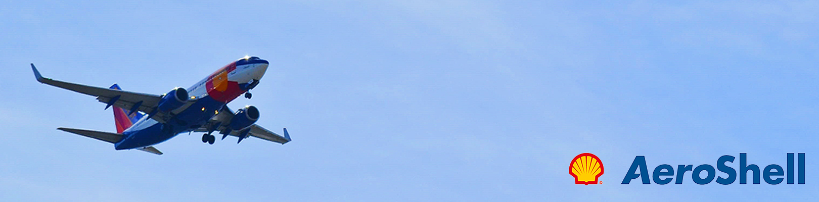 Aircraft in a blue sky with AeroShell logo